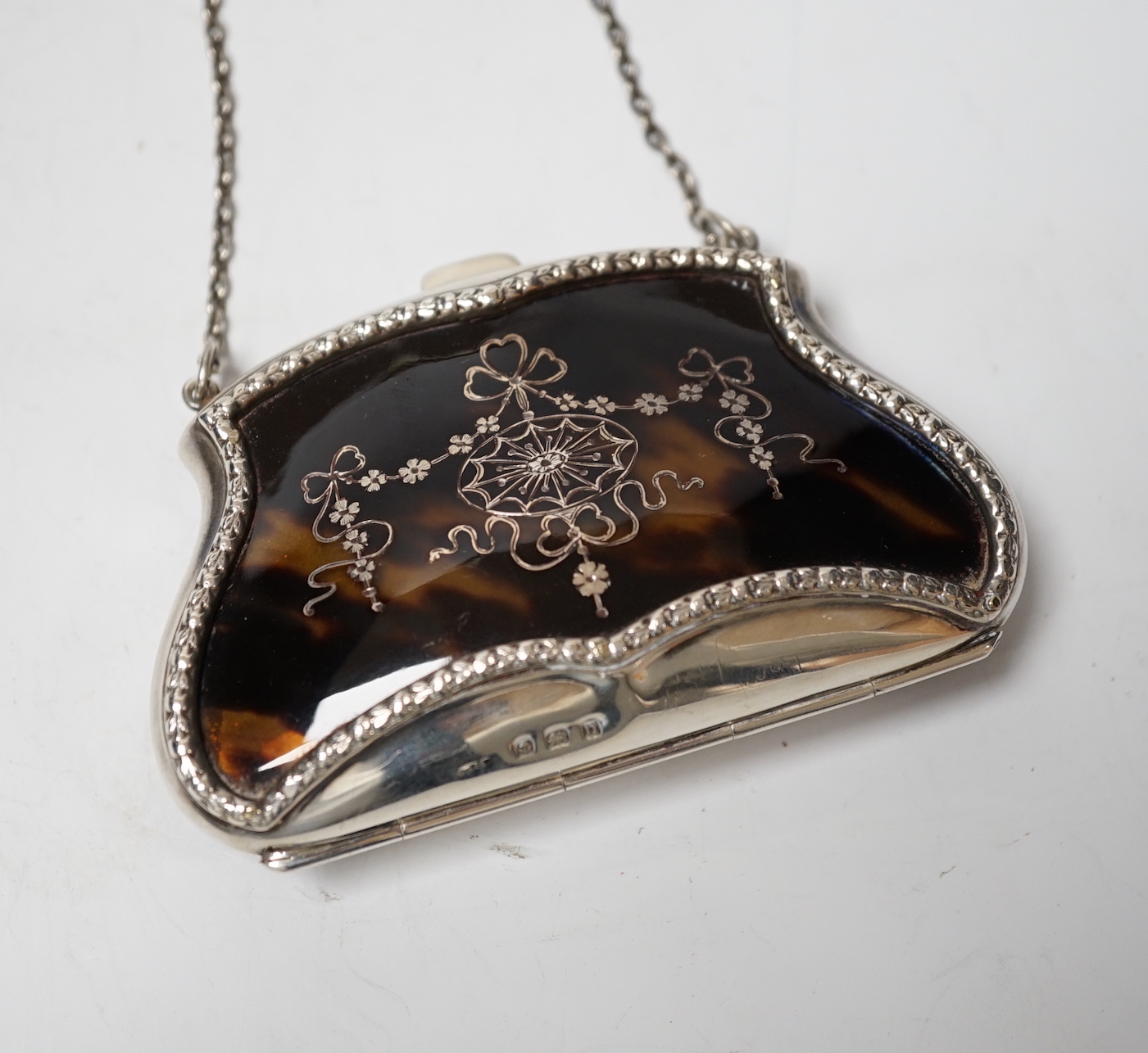 A George V silver and tortoiseshell purse, with suspension chain, E.S. Barnsley & Co, Birmingham, 1912, width 9cm.